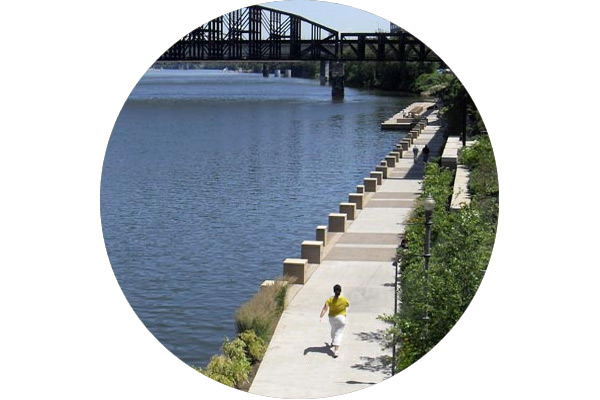 Person running on a riverfront trail