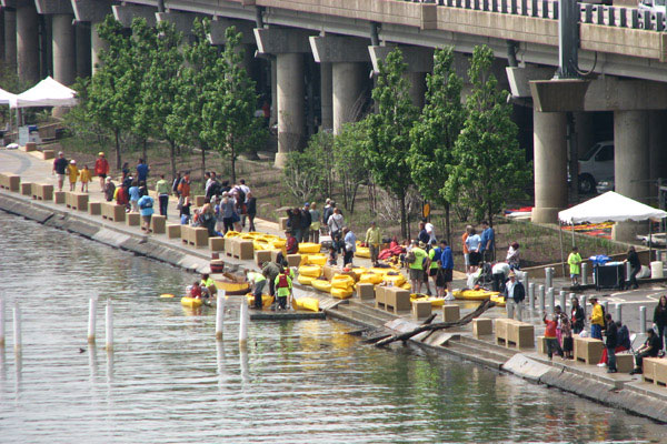 Kayakers line up along the water's edge at the Mon Wharf