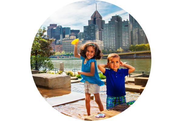 Two children playing at the water steps fountain