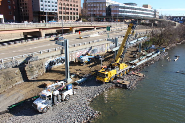 The first section of steel for the Switchback ramp is raised into place on the upriver side of the Smithfield Street Bridge.