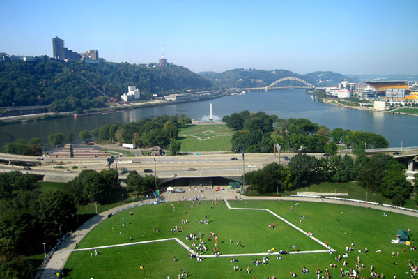 Aerial view of the grassy green lawn filled with people.