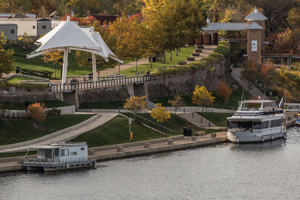 Two large boats are docked next to the park's boat landing on an autumn day.