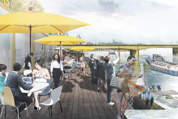 Patrons sit outside a riverfront cafe under yellow umbrellas.