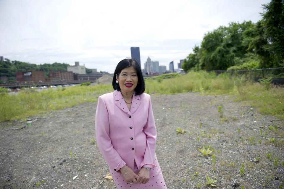 Vivien Li stands near a riverfront parking lot in the Strip District neighborhood.