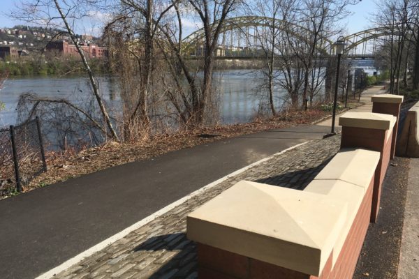 A new brick wall runs along portions of the Three Rivers Heritage Trail in the Strip.