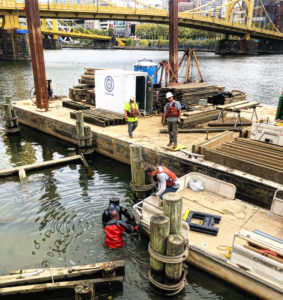 Divers from Marion Hill Associates work on the underwater foundation at the Allegheny Landing boat dock.